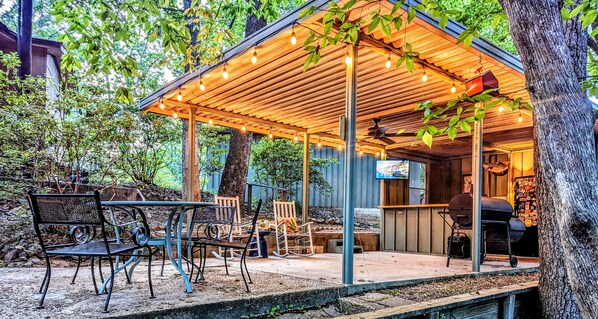 Outdoor bar & grill, refrigerator, sink with granite countertops.