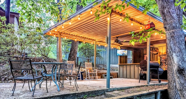 Outdoor bar & grill, refrigerator, sink with granite countertops.