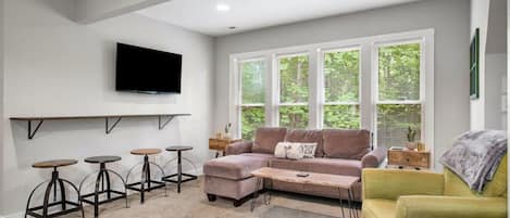 Upper level living room with ample seating and flat-screen Roku TV.