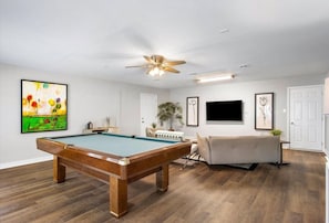 First floor living area with ample seating, flat-screen Roku TV and pool table. Pool balls and cue sticks provided.