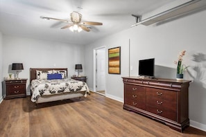 Secondary bedroom on lower level with queen-sized bed and flat-screen Roku TV.