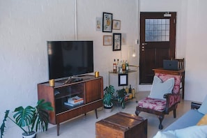 The open plan lounge. 48inch smart TV with Netflix and youtube. work station looking out at the pool area. Please note the drinks trolley is no longer available due to licensing laws. We can provide the trolley but you must BYOB.