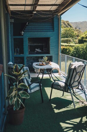 Your private balcony with braai (bbq) and pull down blinds for rainy or windy weather. Lovely valley views from here.