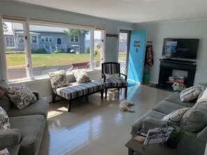 Large living area with picture window looking out at the ocean.