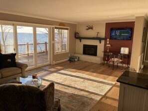 Living area with walk out deck to lake 