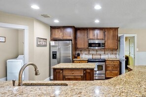 Full size kitchen with huge pantry and custom cabinets.