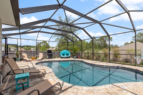 Huge screened in pool deck with loungers and resort style lounger.  