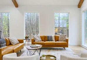 Sink into these sofas and let the forest view soothe your soul