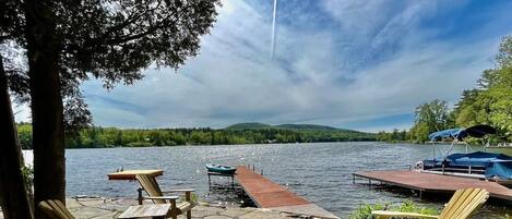 Adirondack chairs with lake and dock views