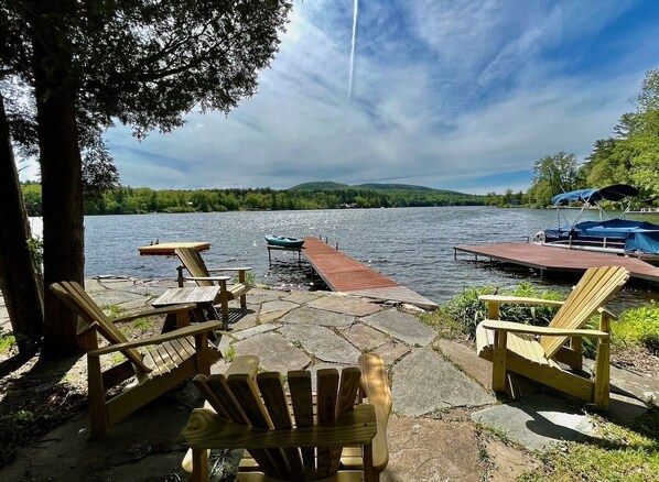 Adirondack chairs with lake and dock views