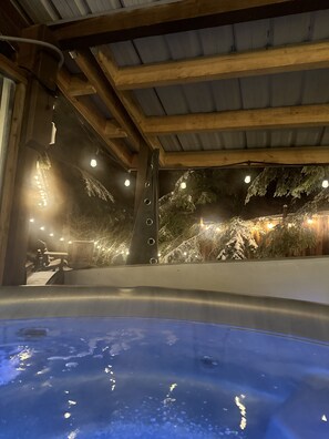 Enjoy the covered hot tub amongst a natural setting