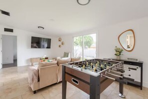 Enjoy our soccer table and a great smart TV, all in one space.