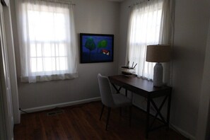 A quiet workspace is tucked away, overlooking the back yard.
