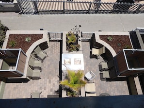 Patio on Ground Level. Unit is on the right. Equipped with BBQ and Outdoor Shower.