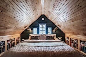 This upstairs loft area is so cozy with its comfy king bed and hundreds of books.