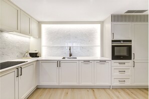 Hand made designer kitchen with Carrara Mable inset and integrated appliances.