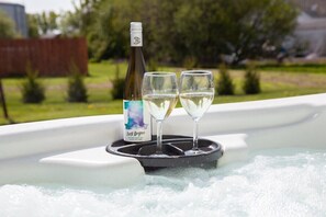 Unwind in the hot tub with a view and a glass of Finger Lakes wine.