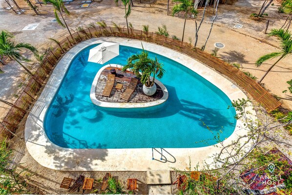 An aerial shot of the gorgeous pool with deserted island!