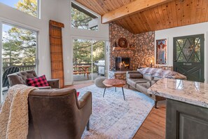 Hang out space in front of river stone fireplace in 2nd floor living room