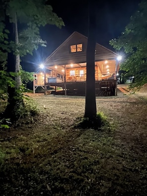 White Tail View at night. Enjoy the outdoors on the wrap around porch. 