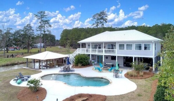 Two story lakefront house with pool and two private boat docks with lifts