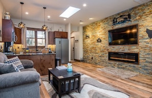 As you enter the unit you are greeted by a spacious living area with cozy seating in front of the fire