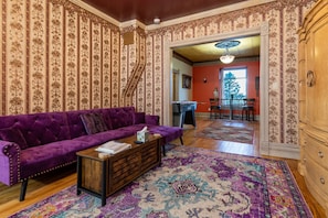 As you walk in the unit you are greeted by an open living space with beautiful period decor