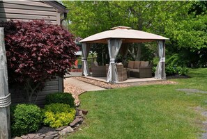 Relax under the gazebo with our comfy outdoor furniture.