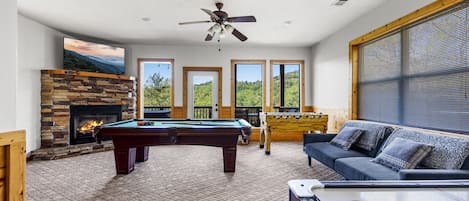 Lower level deck just off the game room has hot tub and table for 6!