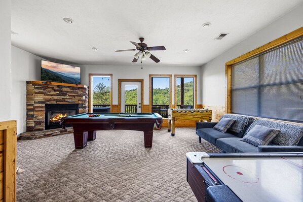 Lower level deck just off the game room has hot tub and table for 6!
