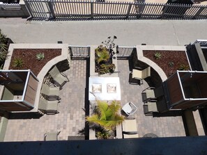 View of the Patio from Top Floor Balcony. Equipped with 2 BBQ and 2 Outdoor Showers