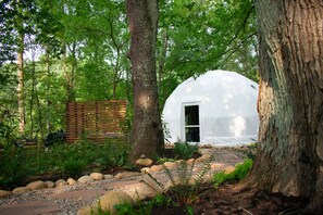 Locally sourced stone pathway leading to dome.