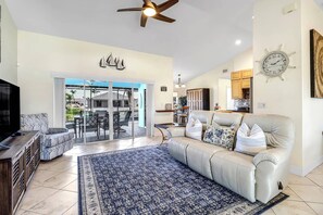 Vaulted ceilings and generous sliding glass doors in the main living area fill the space with a bright, airy atmosphere.