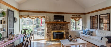 Cozy living area with fireplace and TV, perfect for family get togethers.