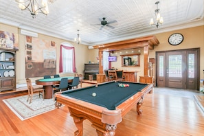 It's game time. Enjoy playing billiards, poker and other games with the bar on the side