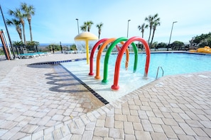 Kids splash area at pool by ocean