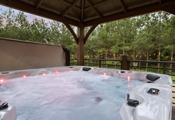 Soak and relax in our outdoor hot tub, surrounded by nature.