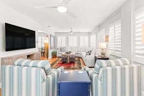 The living area with a flat-screen TV and Queen sleeper sofa