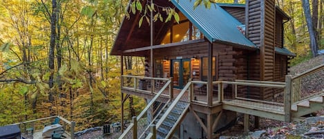 Outside of cabin large deck and hot tub.