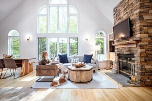 Our grand, open concept living space, which includes our living room, dining, area and kitchen. Our windows lookout on to our deck and outdoor patio area.