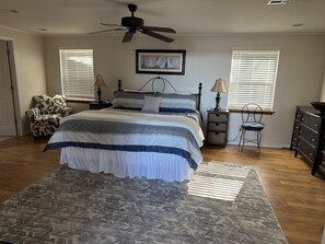 Spacious primary bedroom with King sized bed and couch with full size pull-out