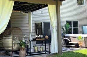 Back yard privacy.  View of 6 person hot tub and sitting area outside of walk out basement game room and bunk room. 