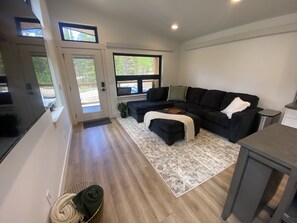 Fantastic living room with lots of windows  and a large Roku TV 