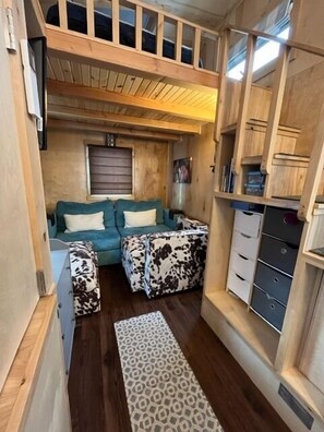 Plenty of dressers & drawers, plus under couch storage! Stairs to loft bedroom with queen bed