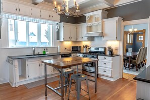 Additional view of kitchen. Pots, pans, dinnerware and silverware, glass storage containers, cooking utensils, basic spices, and more.  