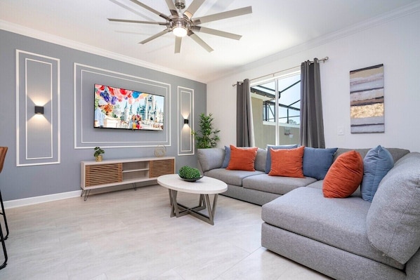 Step into this spacious, comfortable living area. The expansive room is adorned with tasteful decor, offering a blend of modern aesthetics and homey warmth.