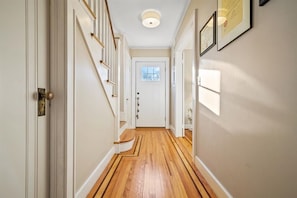 Bright and inviting hallway to front door.