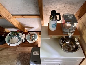 The sink set up with kitchen basics for cooking under the deck.