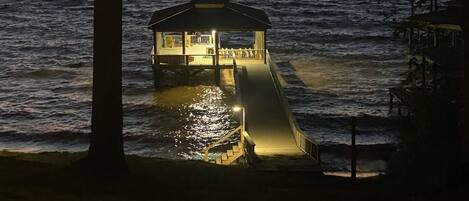 The private boathouse all lit up during sunset.  