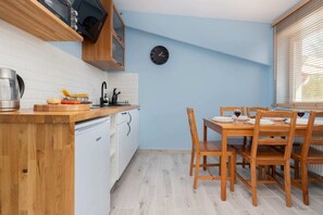 Spacious dining area with fully equipped kitchenette.
